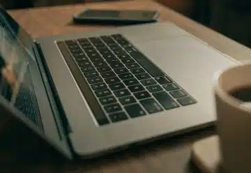 macbook pro on brown wooden table