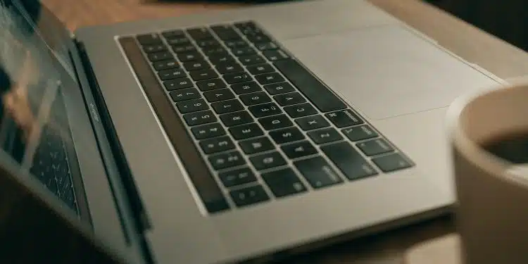 macbook pro on brown wooden table