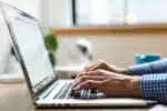 person typing on silver MacBook