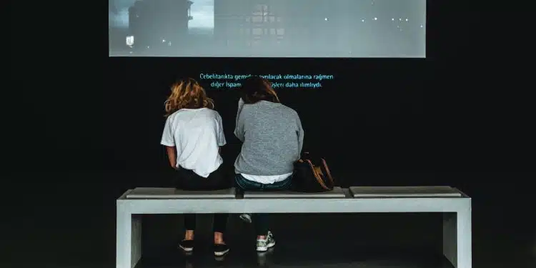 two women sitting on table